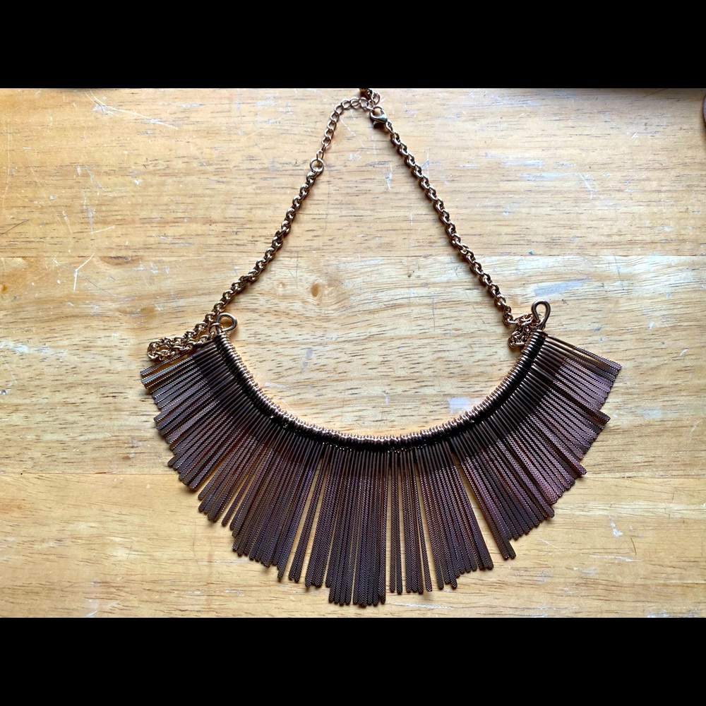 Gold necklace. No brand. Looks a lot more gold than this photo.